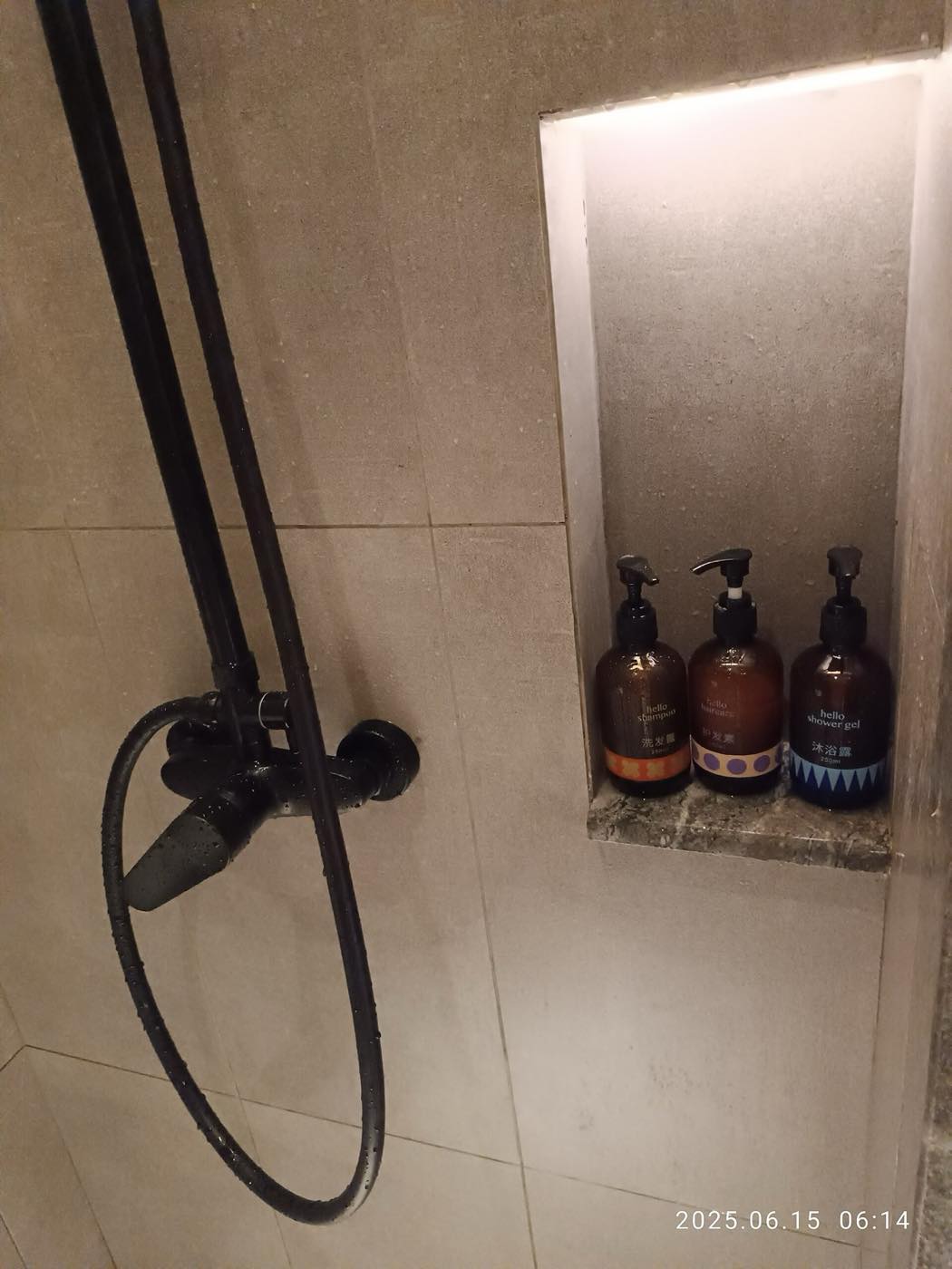 A private bathroom with a shower and a hot water tap