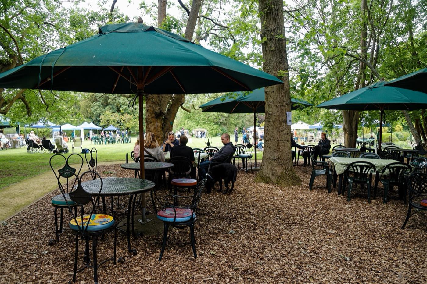 Garden seating in the grounds of the hotel with trees behind